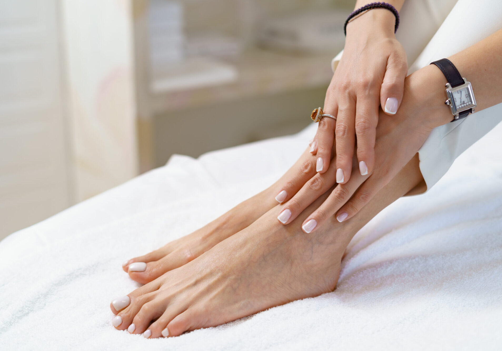 Manicure pedicure close up on white perfect shape hands spa salon