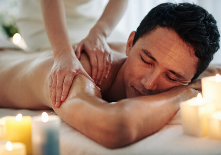 Handsome middle-aged man enjoying relaxing spa massage with oils